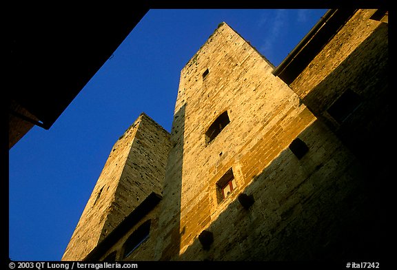 Medieval tower seen from the street, early morning. San Gimignano, Tuscany, Italy