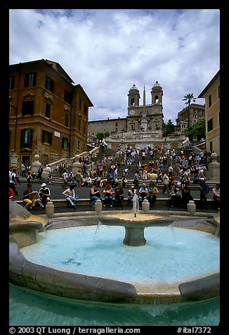 Fontana della Barcaccia and Spanish Steps covered with tourists sitting. Rome, Lazio, Italy