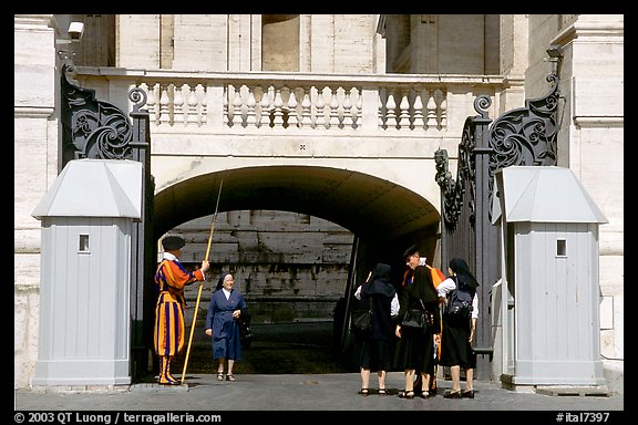 Nuns move past checkpoint manned by Swiss guards. Vatican City