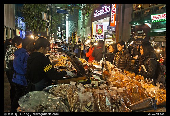 Unusual street foods on busy shopping street. Seoul, South Korea
