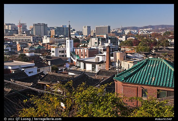 Hanok houses overlooking modern skyline. Seoul, South Korea (color)