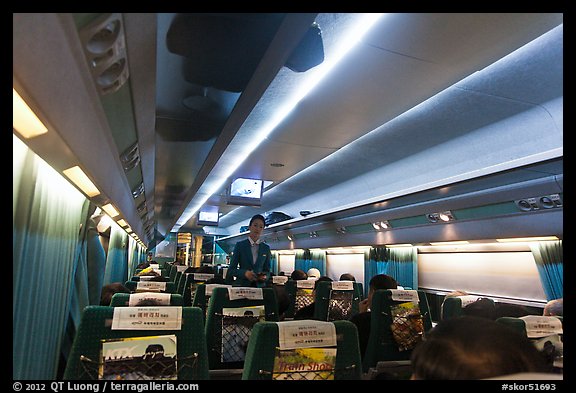 Hostess walking inside high speed KTX train car. Seoul, South Korea