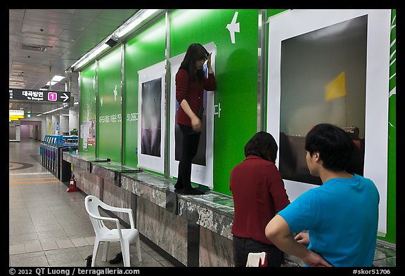 Photography exhibit being installed in subway. Daegu, South Korea (color)