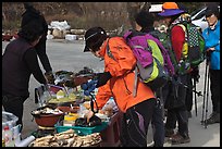 Hikers check out stand selling natural products. South Korea (color)