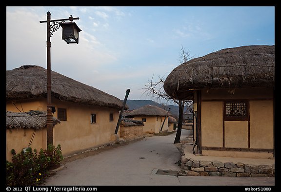 Alley bordered by straw roofed houses. Hahoe Folk Village, South Korea (color)