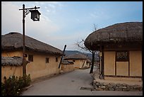 Alley bordered by straw roofed houses. Hahoe Folk Village, South Korea (color)