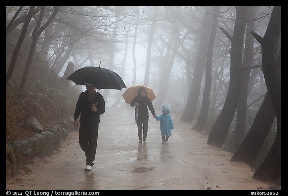 Family walking on path in the rain, Seokguram. Gyeongju, South Korea