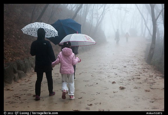 Family walking on misty path, Seokguram. Gyeongju, South Korea