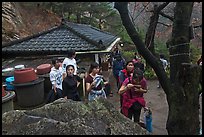 Hikers drinking from foundtain at Sangseonam hermitage, Namsan Mountain. Gyeongju, South Korea