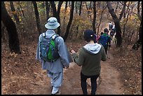 Monk and hikers on trail, Namsan Mountain. Gyeongju, South Korea (color)