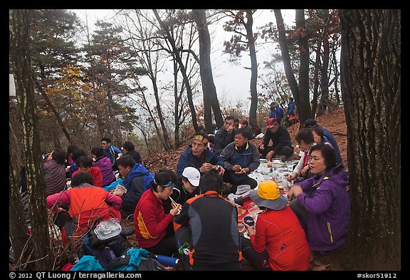 Large group of hikers eating on Geumobong Peak, Namsan Mountain. Gyeongju, South Korea