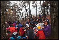 Large group of hikers eating on Geumobong Peak, Namsan Mountain. Gyeongju, South Korea (color)