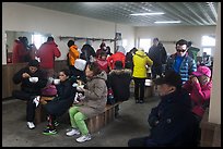 Hikers eating noodles inside Witseoreum shelter, Hallasan. Jeju Island, South Korea (color)