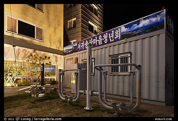 Public exercise equipment and buildings at night, Seogwipo. Jeju Island, South Korea