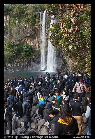 Crowd at the base of waterfall, Jeongbang Pokpo, Seogwipo. Jeju Island, South Korea