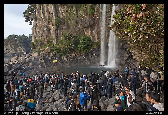 Tourists at the base of Jeongbang Pokpo falls, Seogwipo. Jeju Island, South Korea
