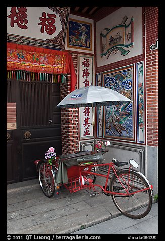 Bicycle rickshaw at temple entrance. George Town, Penang, Malaysia