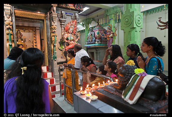 Devotees inside Tamil Nadu temple. George Town, Penang, Malaysia (color)