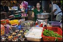 Woman serving dumplings. George Town, Penang, Malaysia (color)
