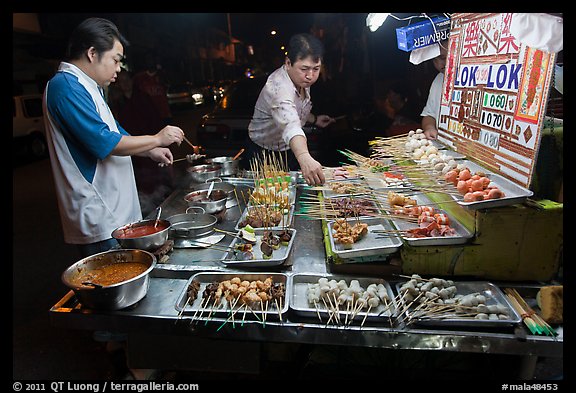Men arranging skewers on hawker stall. George Town, Penang, Malaysia (color)