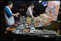 Men arranging skewers on hawker stall. George Town, Penang, Malaysia (color)