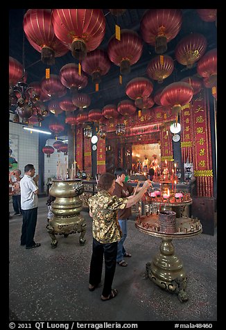 Worshiping inside goddess of Mercy temple. George Town, Penang, Malaysia (color)