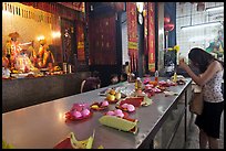 Woman Worshiping inside Chinese temple. George Town, Penang, Malaysia