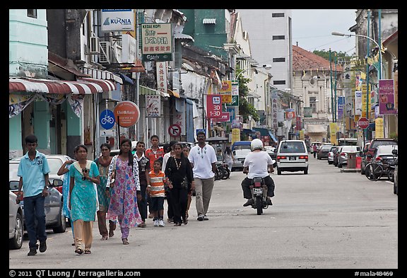 Malay people walking on street. George Town, Penang, Malaysia