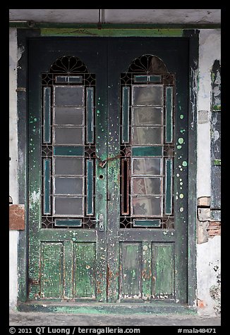 Old green door locked with chain. George Town, Penang, Malaysia