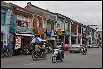 Chinatown street with traffic and storehouses. George Town, Penang, Malaysia (color)