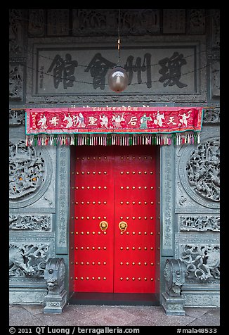 Crimson door and slate wall, Hainan Temple. George Town, Penang, Malaysia