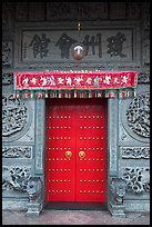 Crimson door and slate wall, Hainan Temple. George Town, Penang, Malaysia
