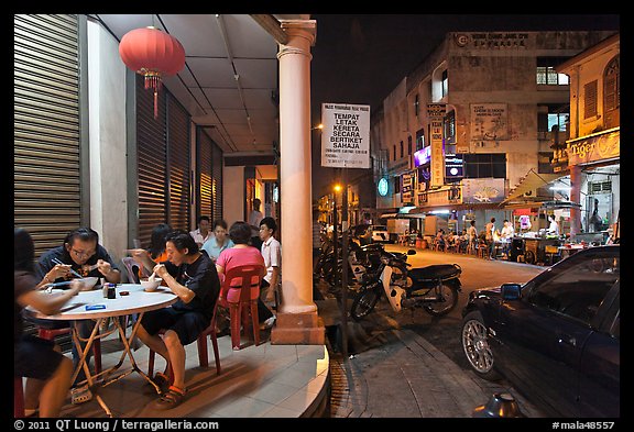 Eating on the street at night. George Town, Penang, Malaysia