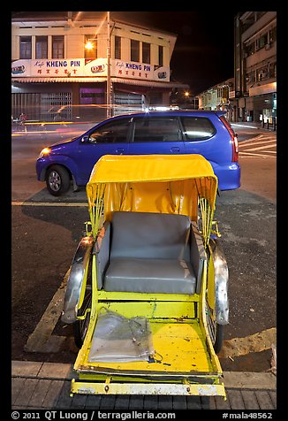Rickshaw and auto at night. George Town, Penang, Malaysia