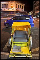Rickshaw and auto at night. George Town, Penang, Malaysia (color)