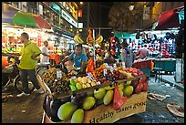 Fruit vendor pushes cart, Jalan Petaling. Kuala Lumpur, Malaysia ( color)
