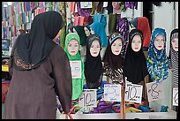 Woman in apparel store with islamic headscarves for sale. Kuala Lumpur, Malaysia