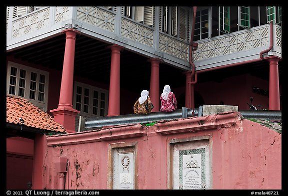 Stadthuys detail with two women. Malacca City, Malaysia