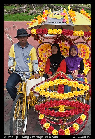 Rider and two women passengers, bicycle rickshaw. Malacca City, Malaysia