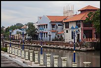 Lamps, riverside houses and St Peters Church towers. Malacca City, Malaysia ( color)