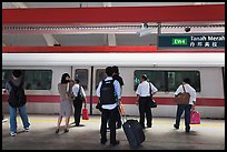 Passengers preparing to board MRT train. Singapore ( color)