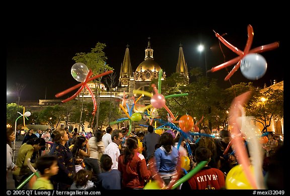 Children playing with ballons on Plaza de la Liberacion by night. Guadalajara, Jalisco, Mexico (color)