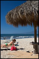 Woman in swimsuit reading on beach chair, Nuevo Vallarta, Nayarit. Jalisco, Mexico (color)