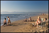 Mothers sitting on beach chairs watching children play in sand, Nuevo Vallarta, Nayarit. Jalisco, Mexico (color)