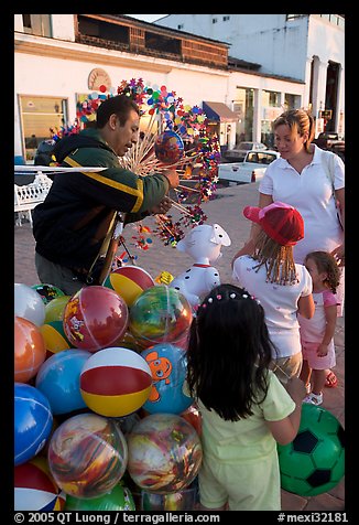 Children, mother, and balloon vendor , Puerto Vallarta, Jalisco. Jalisco, Mexico (color)