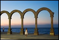 Girl standing by the Malecon arches at sunset, Puerto Vallarta, Jalisco. Jalisco, Mexico ( color)