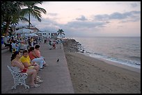 Women sitting on a bench looking at the ocean, Puerto Vallarta, Jalisco. Jalisco, Mexico (color)