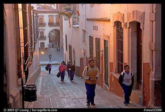 Children heading to school up a narrow cajaon, dawn. Zacatecas, Mexico (color)