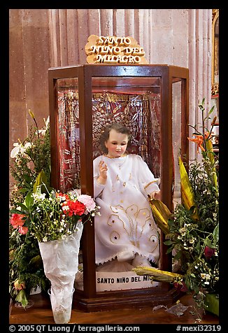 Figure of Santo Nino Del Milagro with offered flowers. Zacatecas, Mexico