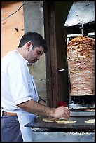Man preparing tacos with meat. Guanajuato, Mexico